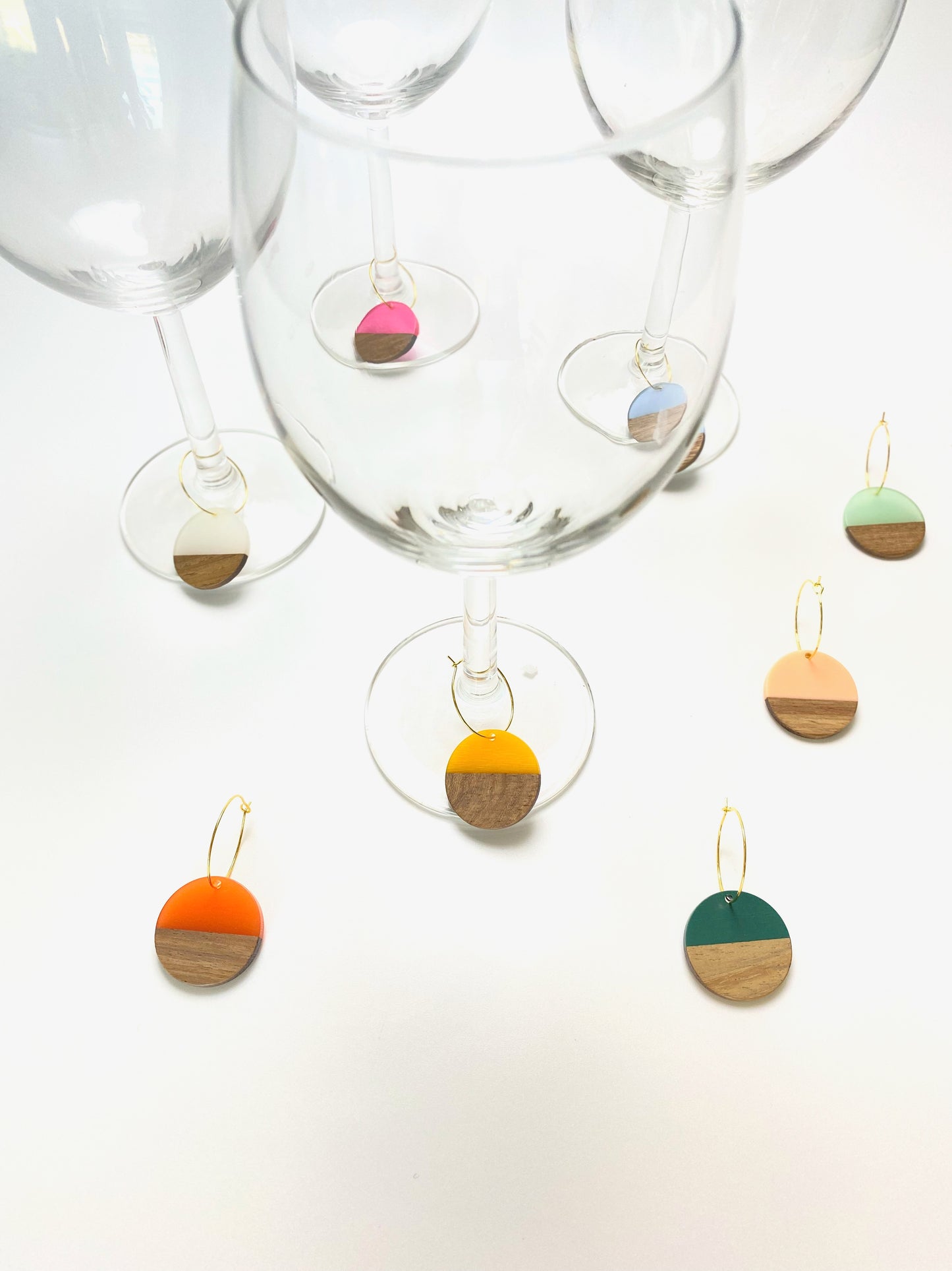 Colorful resin wood circle discs on gold wine charm rings