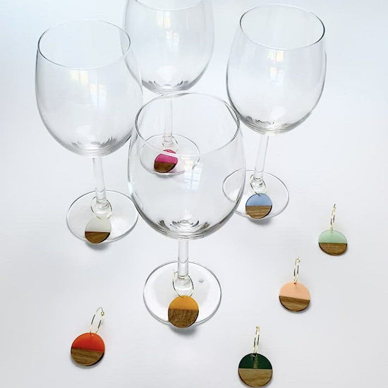 Colorful resin wood circle discs on gold wine charm rings
