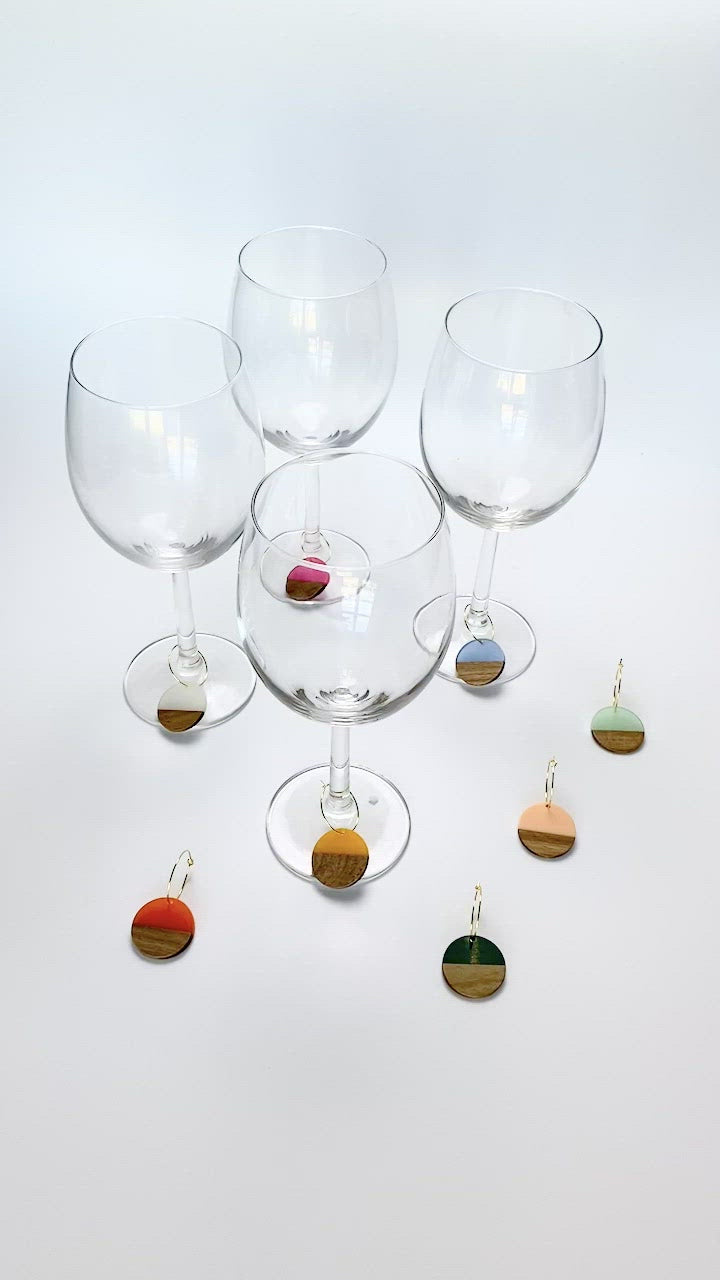 Colorful resin wood circle discs on gold wine charm rings
